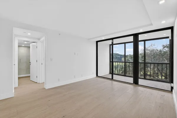 a view of an empty room with glass door
