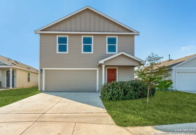 a front view of house with yard and trees