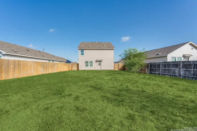 a view of a backyard with plants and a patio