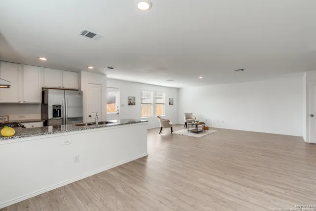 a kitchen with sink and cabinets
