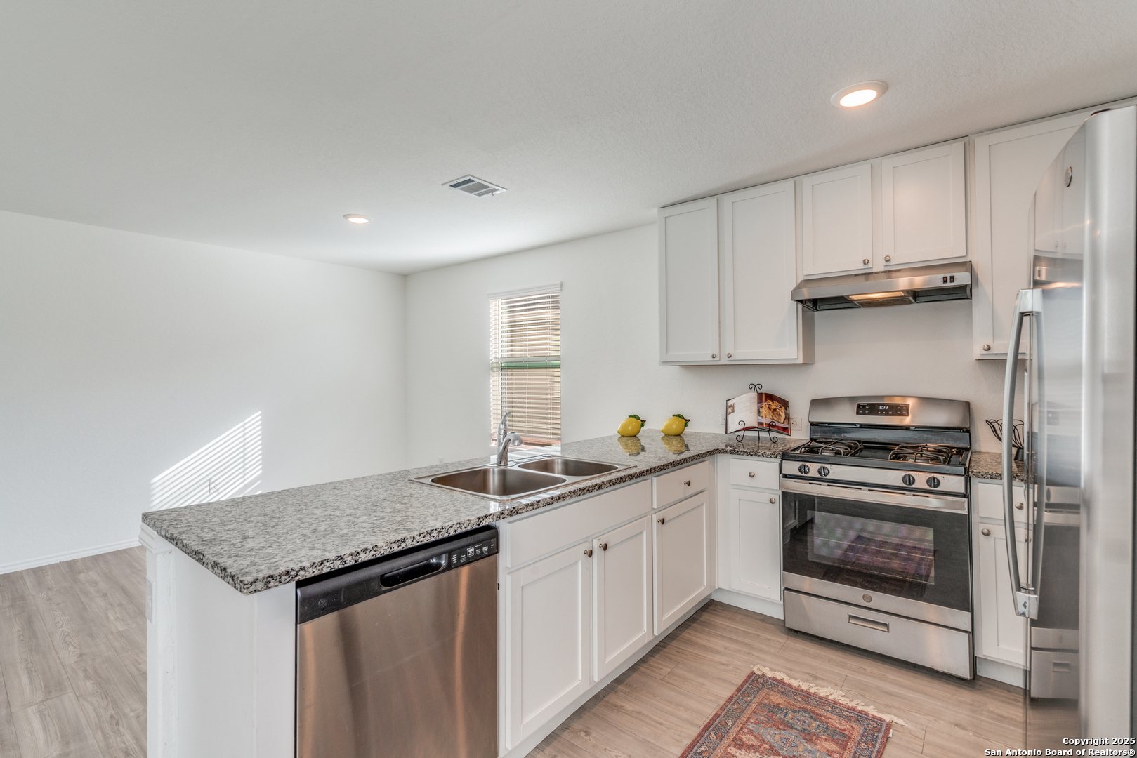 362 Ambush Ridge San Antonio, TX 78220 - Photo 5 of 26 a kitchen with a stove sink and cabinets