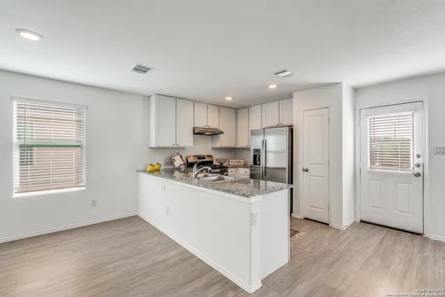a kitchen with a stove a sink and a refrigerator