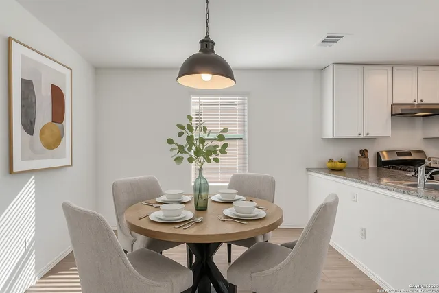 a view of a dining room with furniture and wooden floor