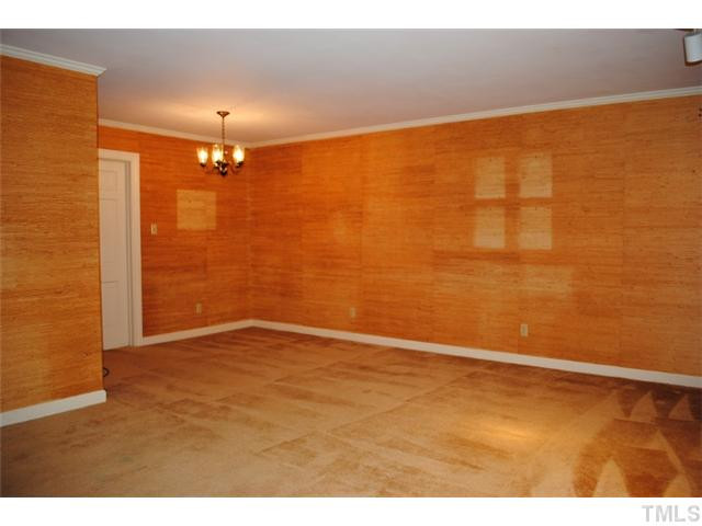 2039 Brogden Road Smithfield, NC 27577 - Photo 19 of 19 The area with a chandelier is the dining room. It adjoins the family room area. The walls are grass cloth. Dining Room