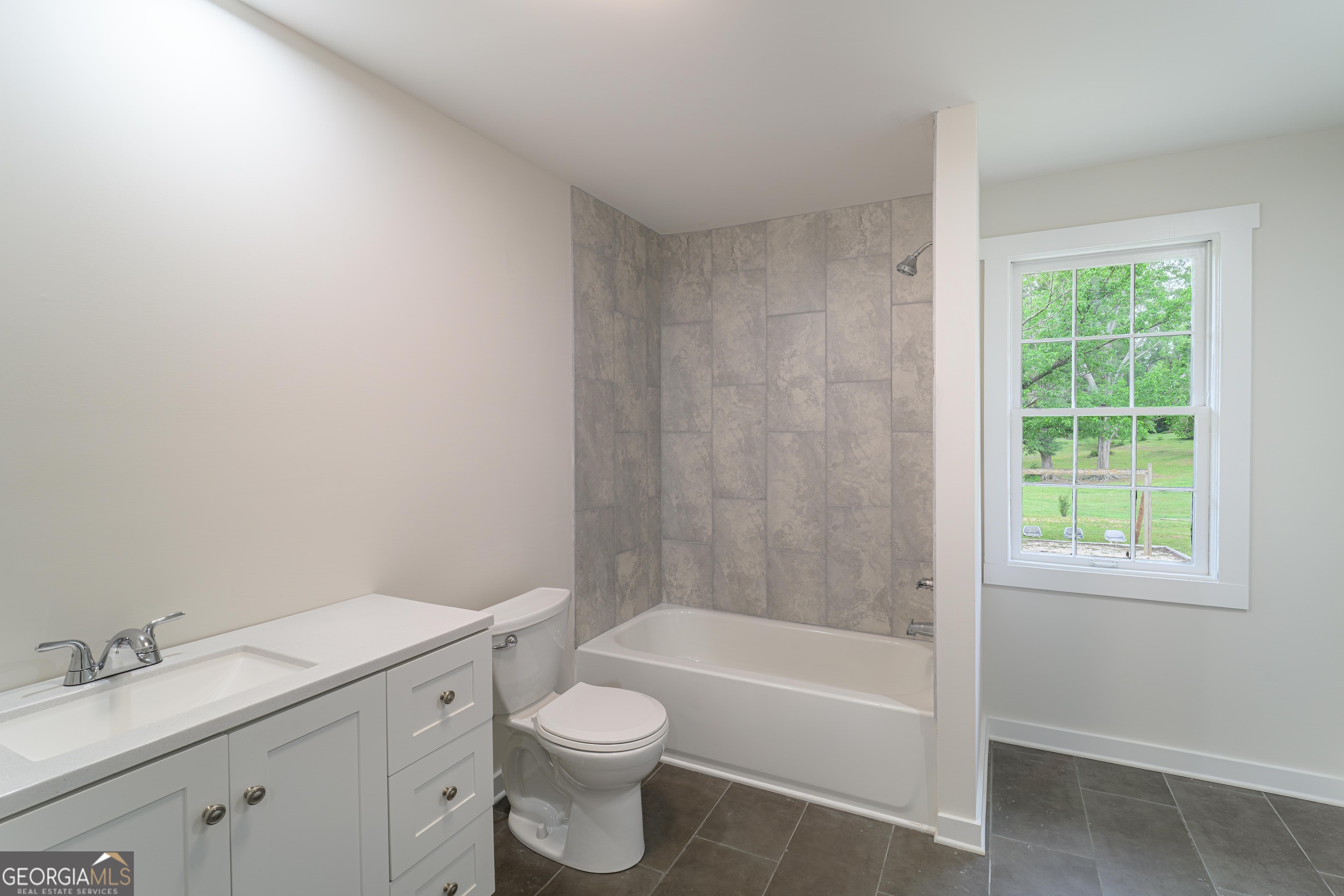 418 Lamb Road Moreland, GA 30259 - Photo 14 of 32 a bathroom with a granite countertop toilet a sink and bathtub