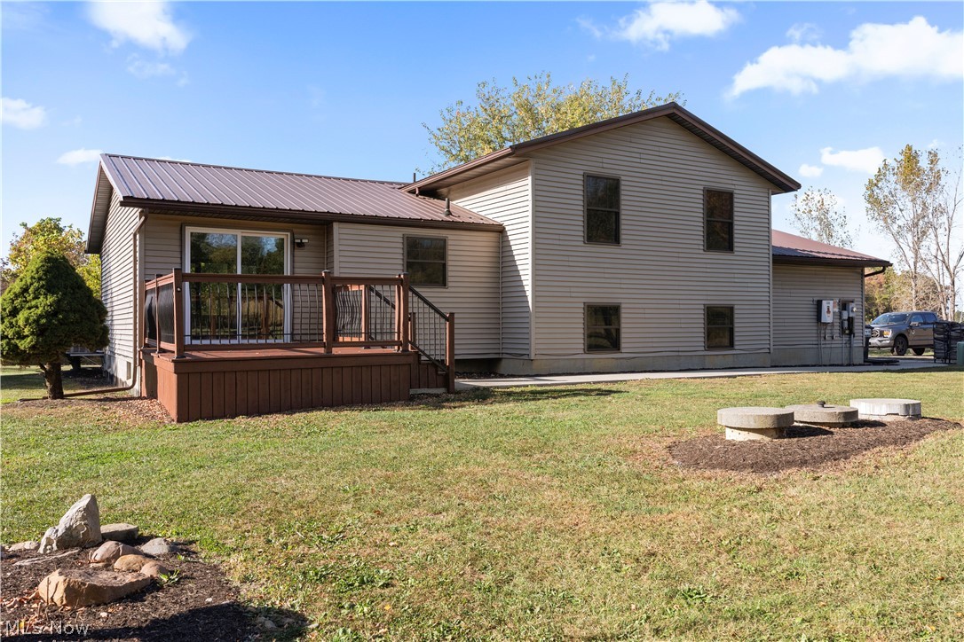 6760 Mason Road Berlin Heights, OH 44814 - Photo 40 of 49 Rear view of house featuring a yard, a deck, a metal roof, and a patio area