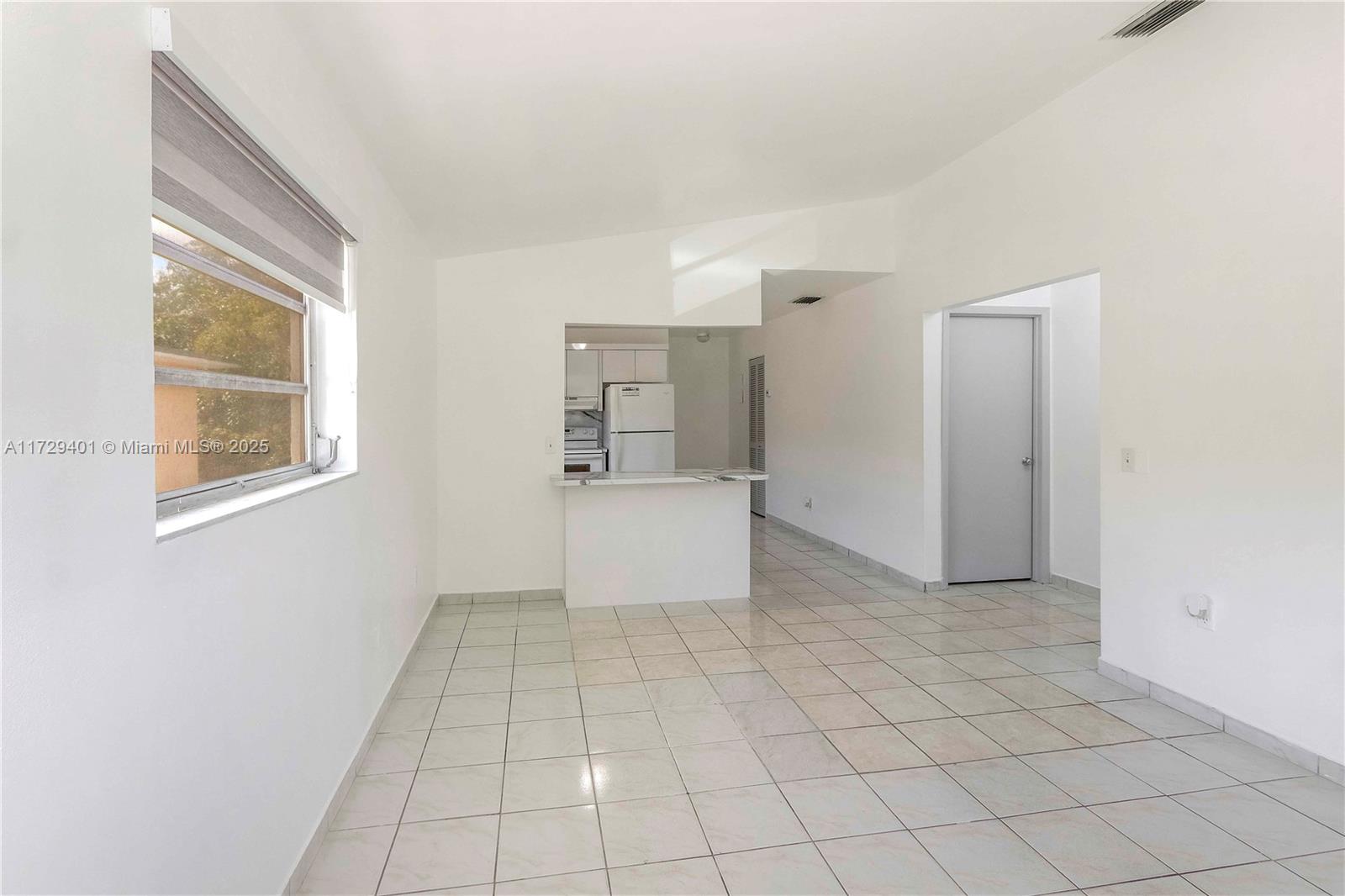 642 East 2nd Avenue, Unit A Hialeah, FL 33010 - Photo 12 of 27 a view of an empty room with a window