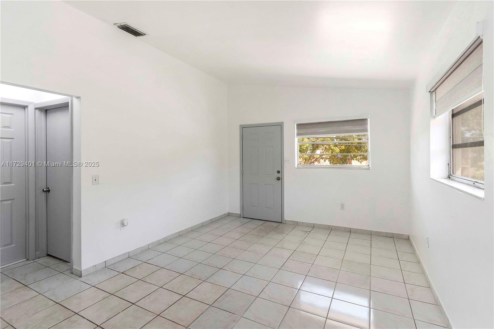 642 East 2nd Avenue, Unit A Hialeah, FL 33010 - Photo 13 of 27 a view of an empty room and window