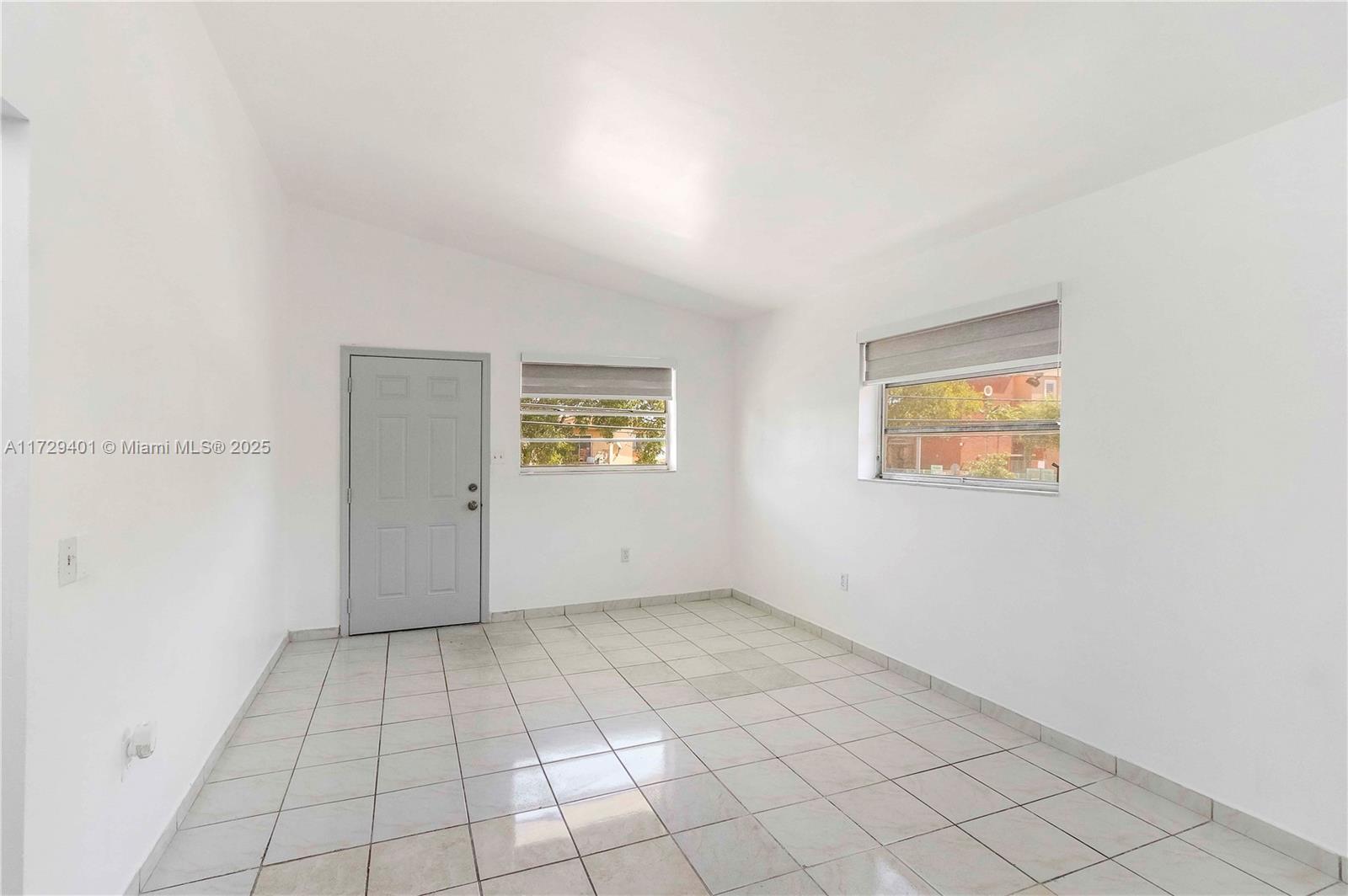 642 East 2nd Avenue, Unit A Hialeah, FL 33010 - Photo 3 of 27 an empty room with windows