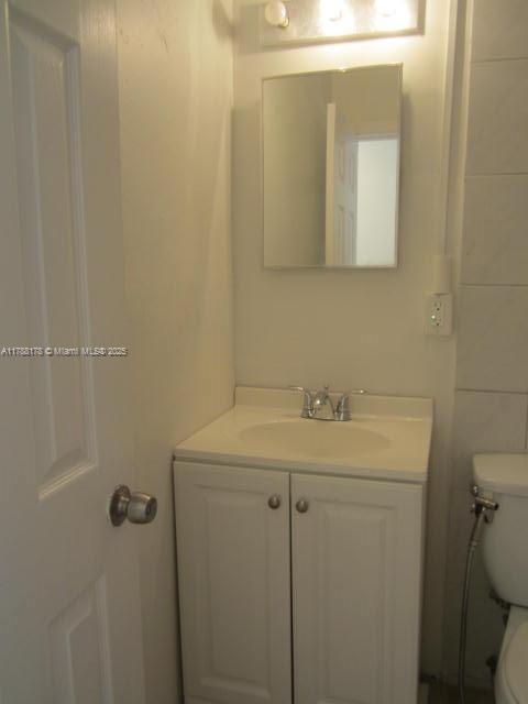 Collier City Pompano Beach, FL 33069 - Photo 11 of 53 a bathroom with a sink and mirror with toilet