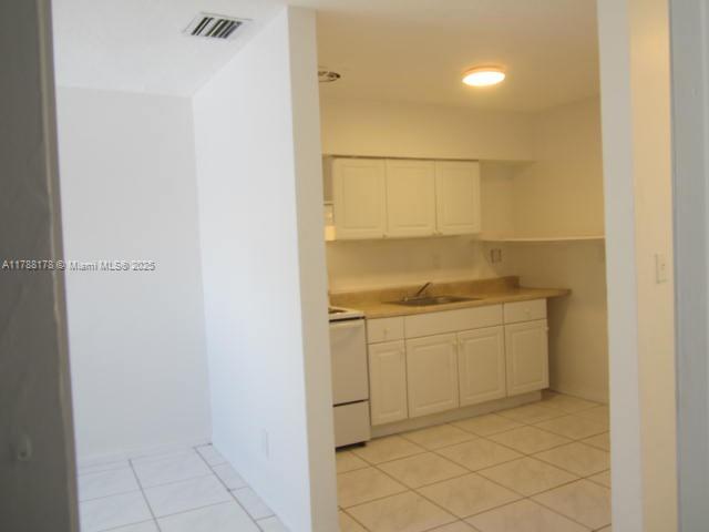 Collier City Pompano Beach, FL 33069 - Photo 43 of 53 a bathroom with a granite countertop sink and a mirror