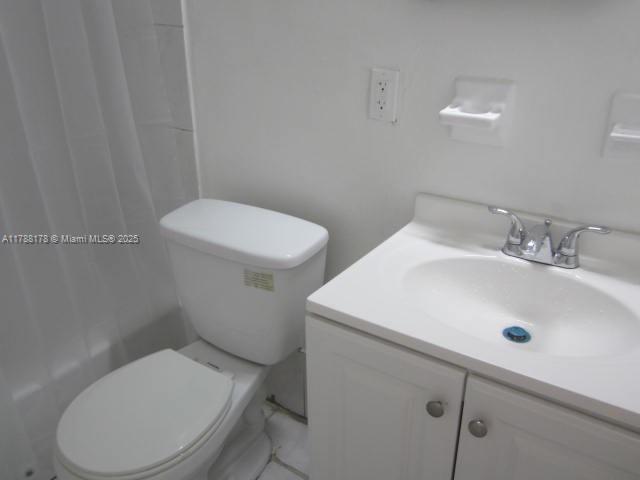 Collier City Pompano Beach, FL 33069 - Photo 52 of 53 a white toilet sitting next to a bathroom sink