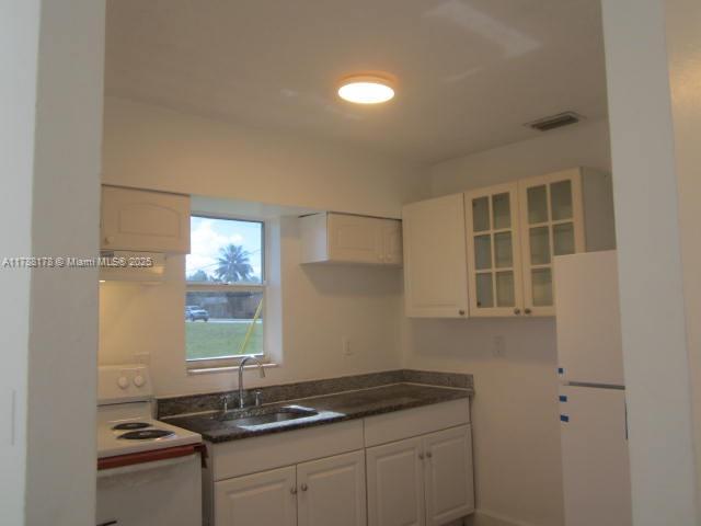Collier City Pompano Beach, FL 33069 - Photo 6 of 53 a kitchen with a sink and cabinets