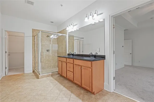 a spacious bathroom with a shower sink and a mirror