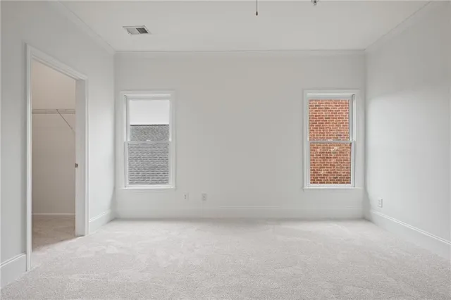 an empty room with windows and closet