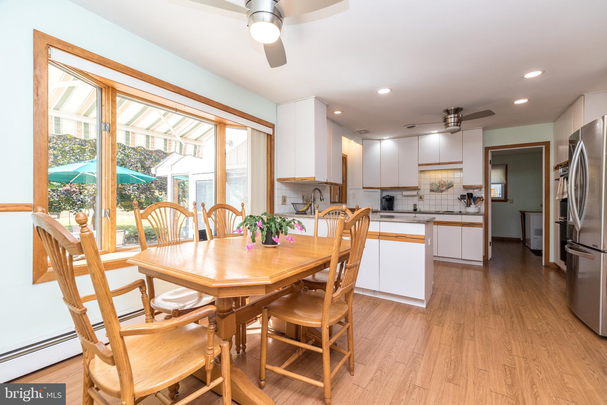 2728 Red Gate Drive Doylestown, PA 18902 - Photo 11 of 42 a dining room with stainless steel appliances furniture large window and wooden floor
