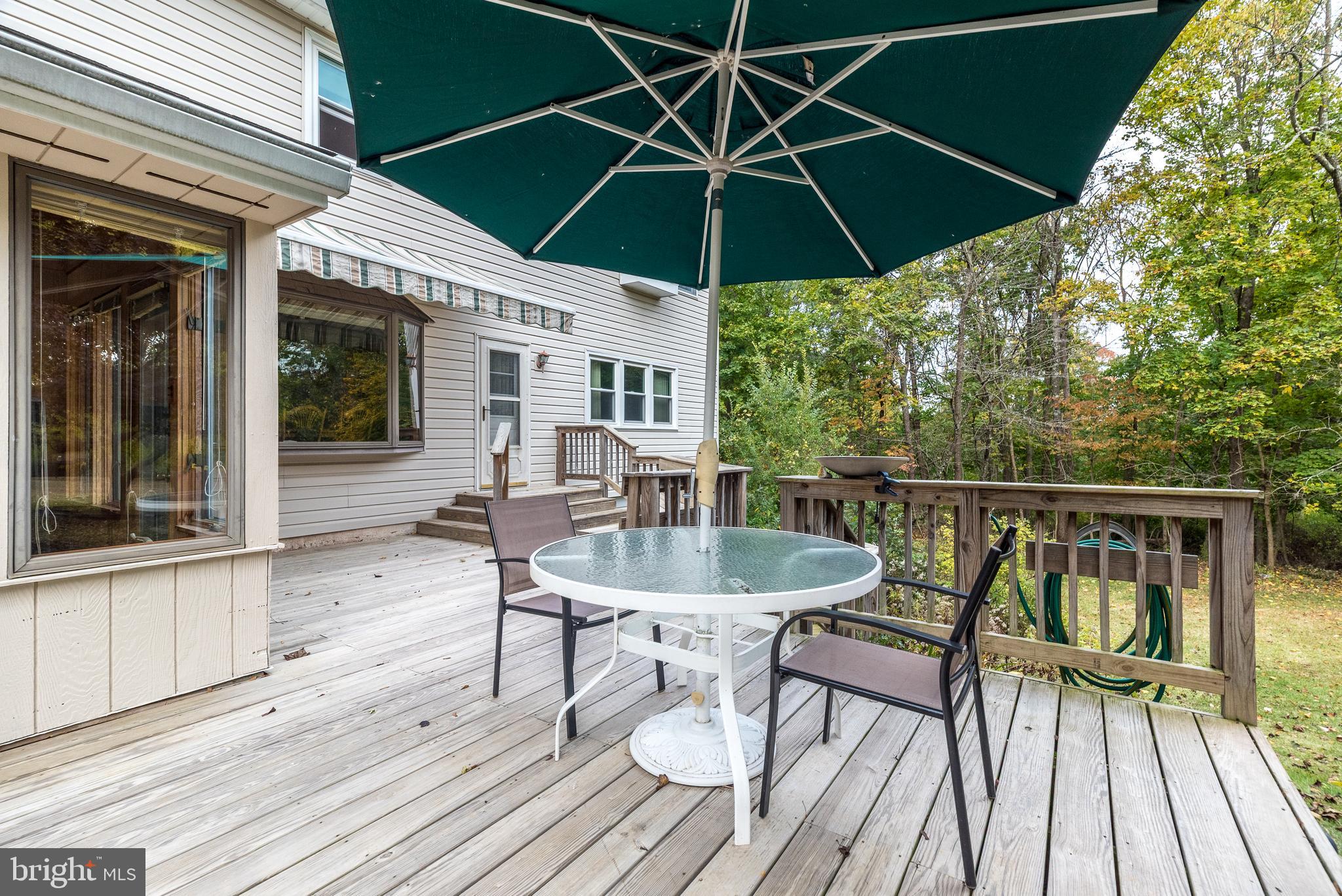 2728 Red Gate Drive Doylestown, PA 18902 - Photo 35 of 42 a patio with wooden floor a yard a table and chairs