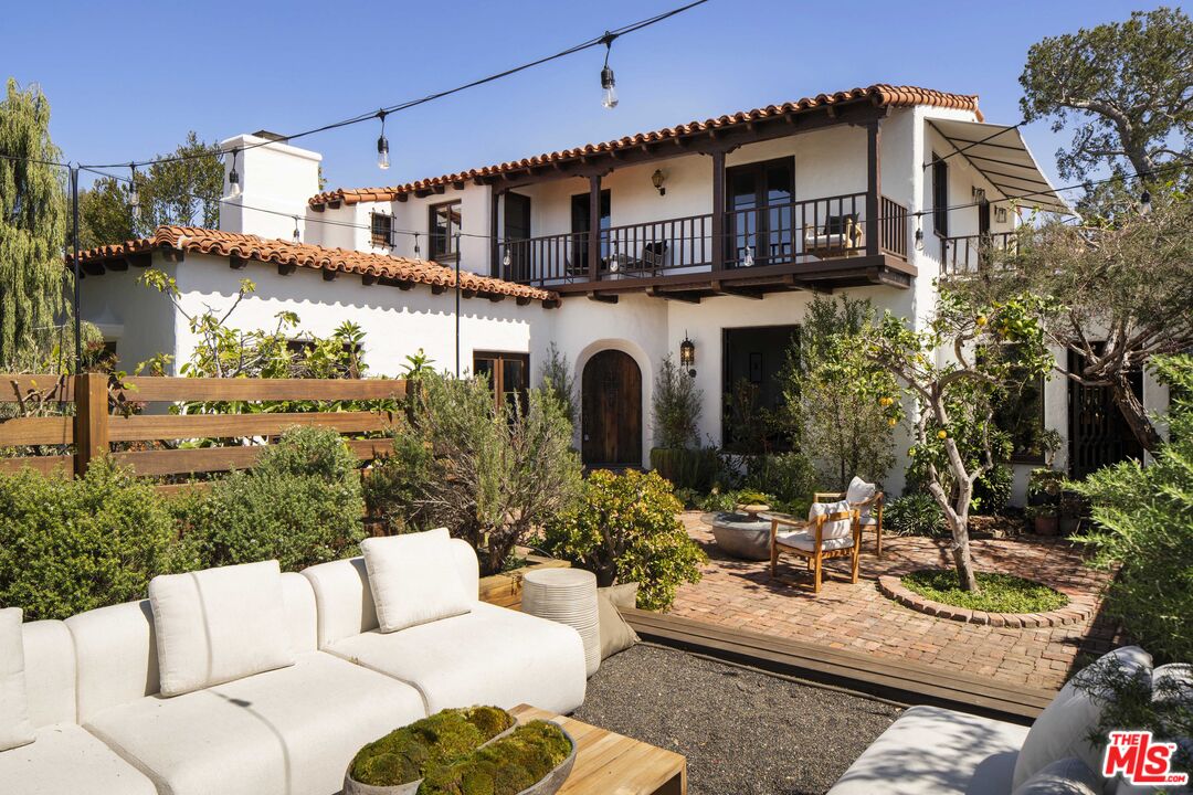 216 Notteargenta Road Pacific Palisades, CA 90272 - Photo 2 of 2 a view of a patio with couches table and chairs potted plants