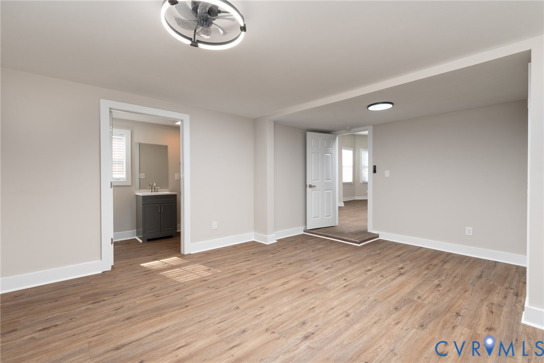 9800 Golf Course Drive Disputanta, VA 23842 - Photo 9 of 19 a view of an empty room with wooden floor and a window