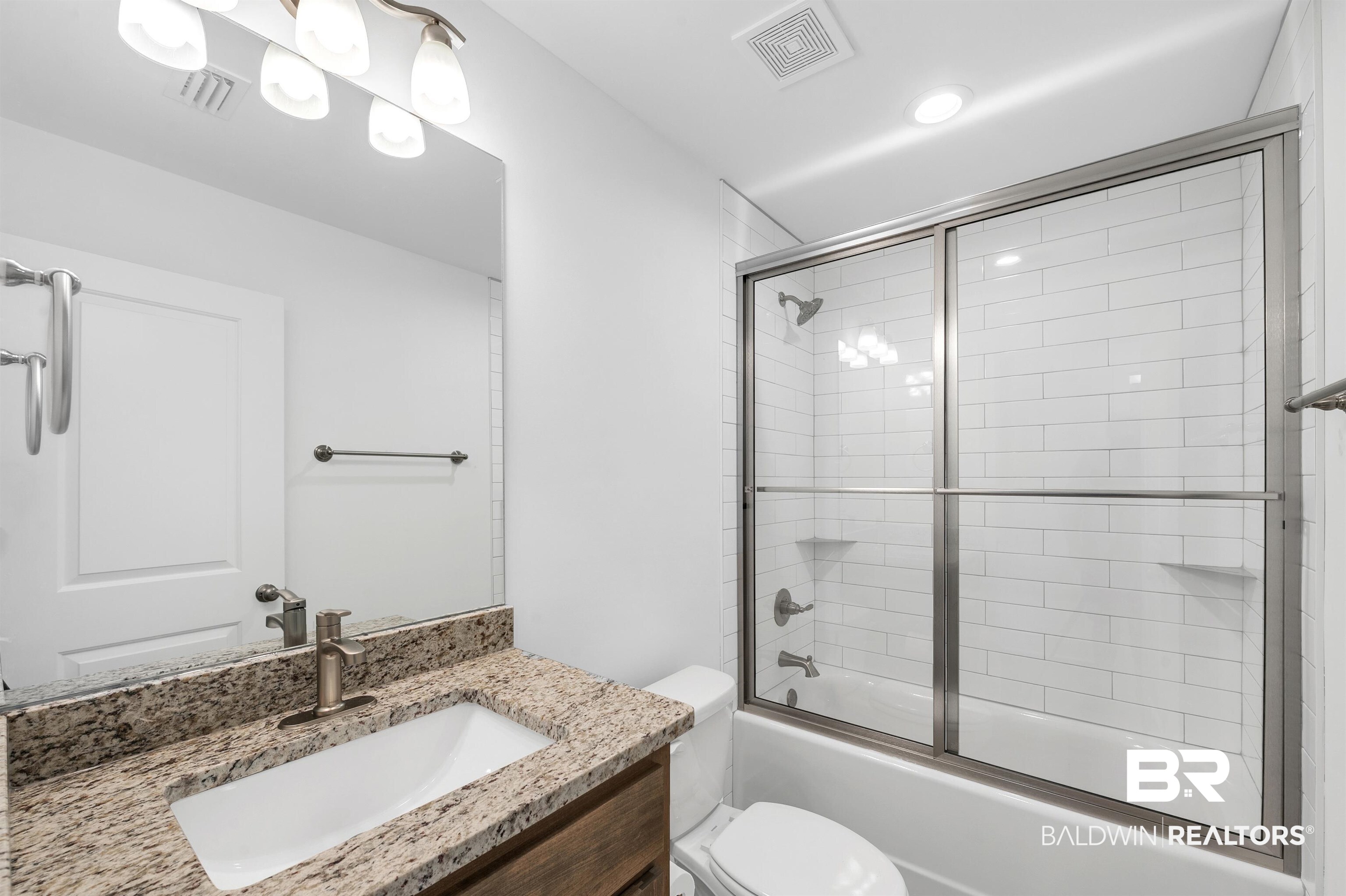 22045 8th Street Silverhill, AL 36576 - Photo 30 of 39 Full bathroom featuring vanity, toilet, enclosed tub / shower combo, and recessed lighting