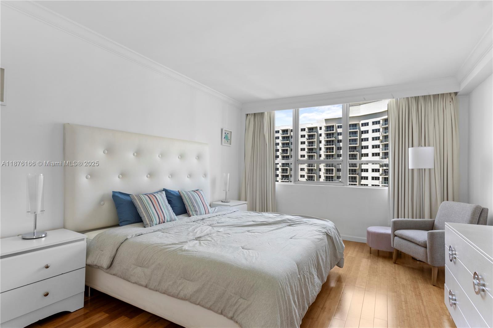 1500 Bay Road, Unit 866S Miami Beach, FL 33139 - Photo 11 of 19 a bedroom with a bed and wooden floor