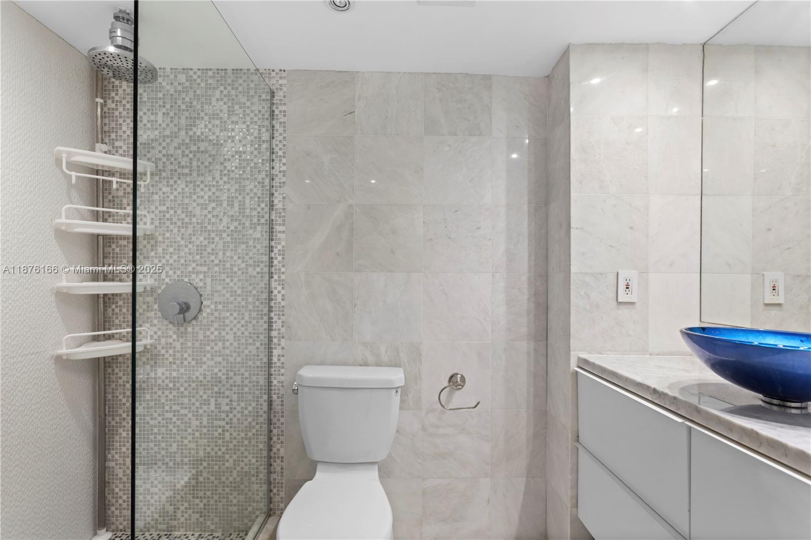 1500 Bay Road, Unit 866S Miami Beach, FL 33139 - Photo 13 of 19 a bathroom with a sink a toilet and shower
