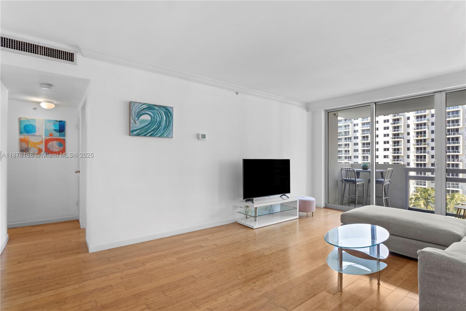 1500 Bay Road, Unit 866S Miami Beach, FL 33139 - Photo 8 of 19 a living room with furniture and a flat screen tv