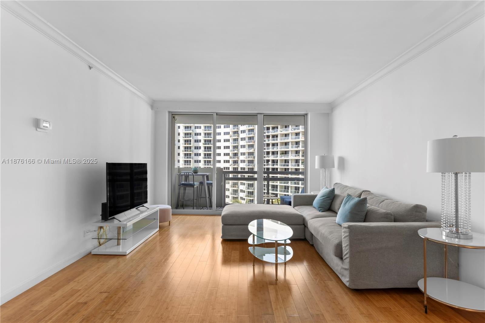 1500 Bay Road, Unit 866S Miami Beach, FL 33139 - Photo 9 of 19 a living room with furniture and a flat screen tv