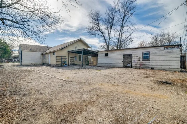 a front view of house with yard and trees in the background