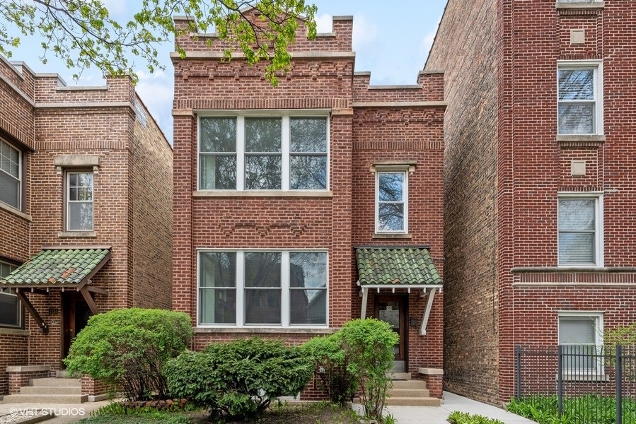 1220 West Roscoe Street Chicago, IL 60657 - Photo 1 of 35 front view of a brick house many windows