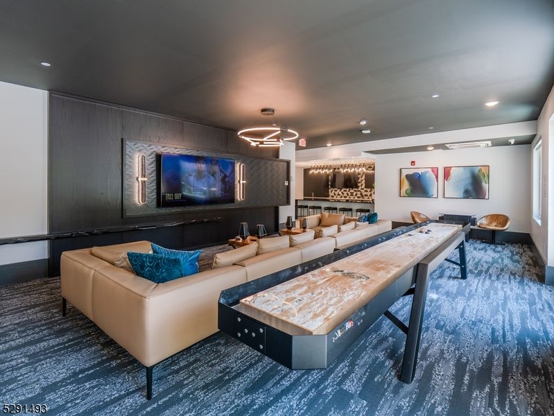 173 Morris Street, Unit 307 Morristown, NJ 07960 - Photo 6 of 17 a living room with furniture and a flat screen tv