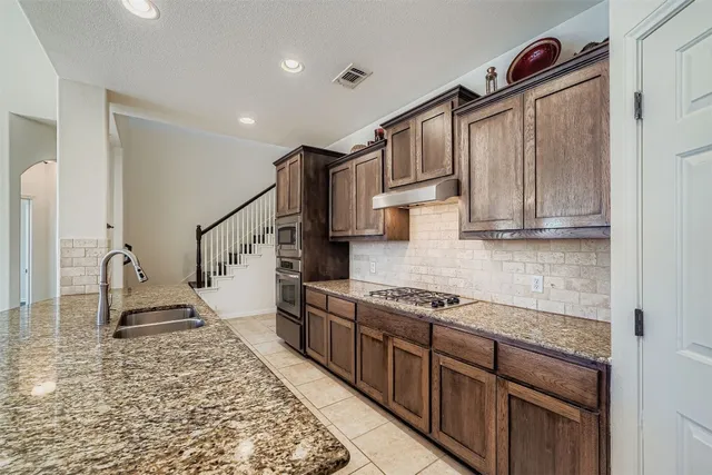a view of a kitchen with a refrigerator a sink and dishwasher