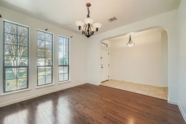 a kitchen with stainless steel appliances granite countertop a kitchen island a stove a sink and a refrigerator