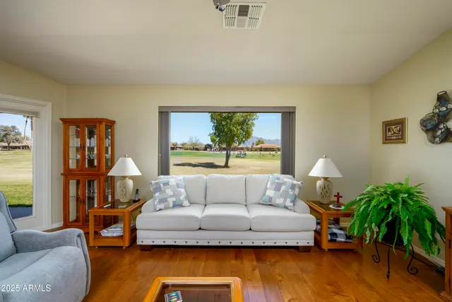 a living room with furniture and a potted plant