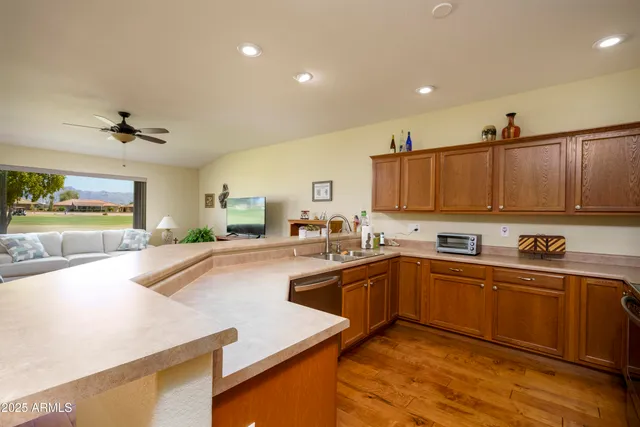 a kitchen with stainless steel appliances granite countertop a sink and cabinets