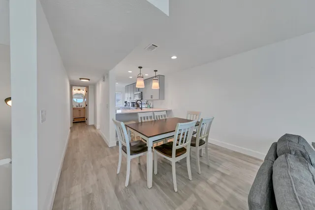 a kitchen with granite countertop a refrigerator stove and sink