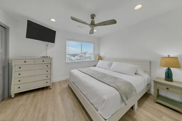 a bedroom with a large bed and a window