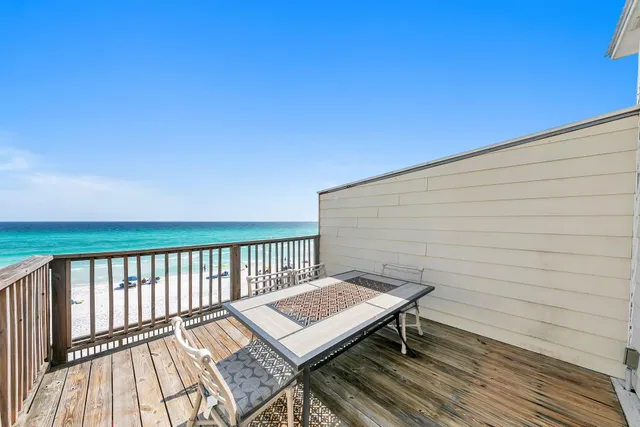 a view of a roof deck with wooden floor and fence