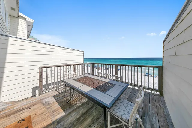 a balcony with wooden floor and city view