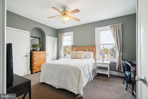 a bedroom with a bed next to a window with outer view