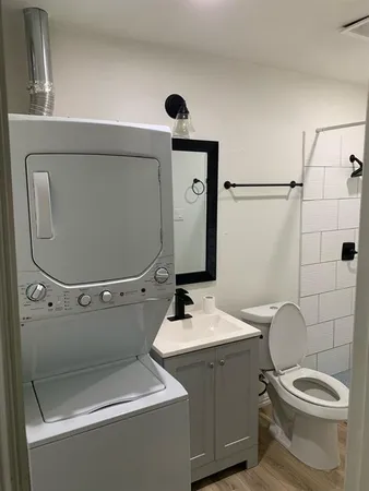 a bathroom with a toilet sink and mirror