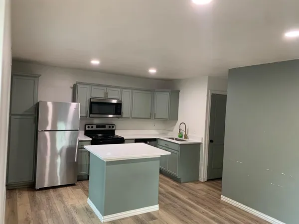 a kitchen with a refrigerator and a sink
