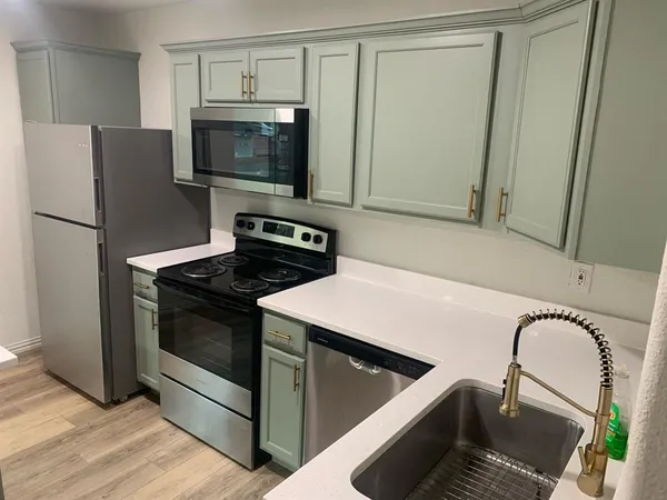 a kitchen with a stove microwave and refrigerator