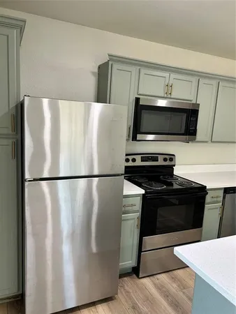 a white refrigerator freezer sitting in a kitchen