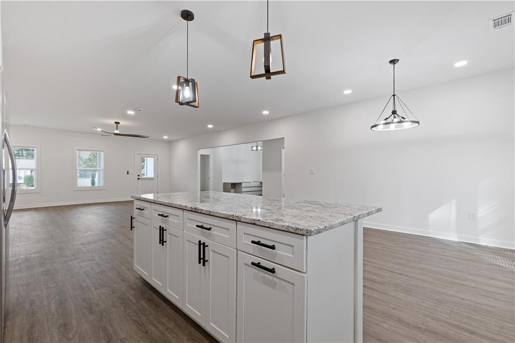 3272 Corktree Trail Lithonia, GA 30038 - Photo 3 of 22 a kitchen with a sink chandelier and wooden floor