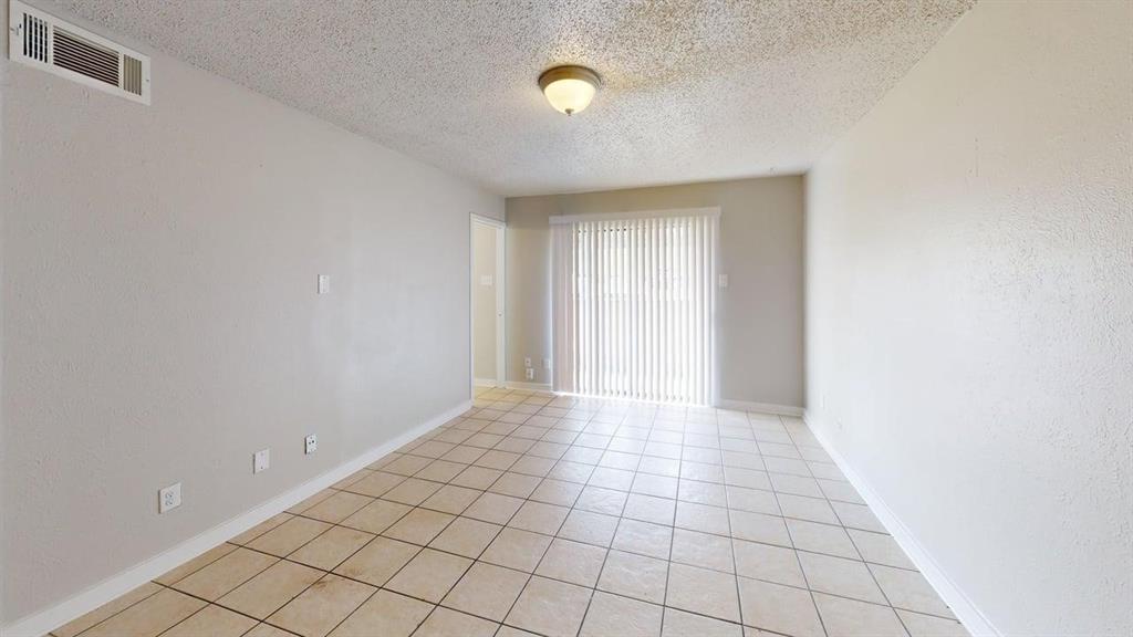 8110 Skillman Street, Unit 1046 Dallas, TX 75231 - Photo 5 of 10 a view of an empty room and window