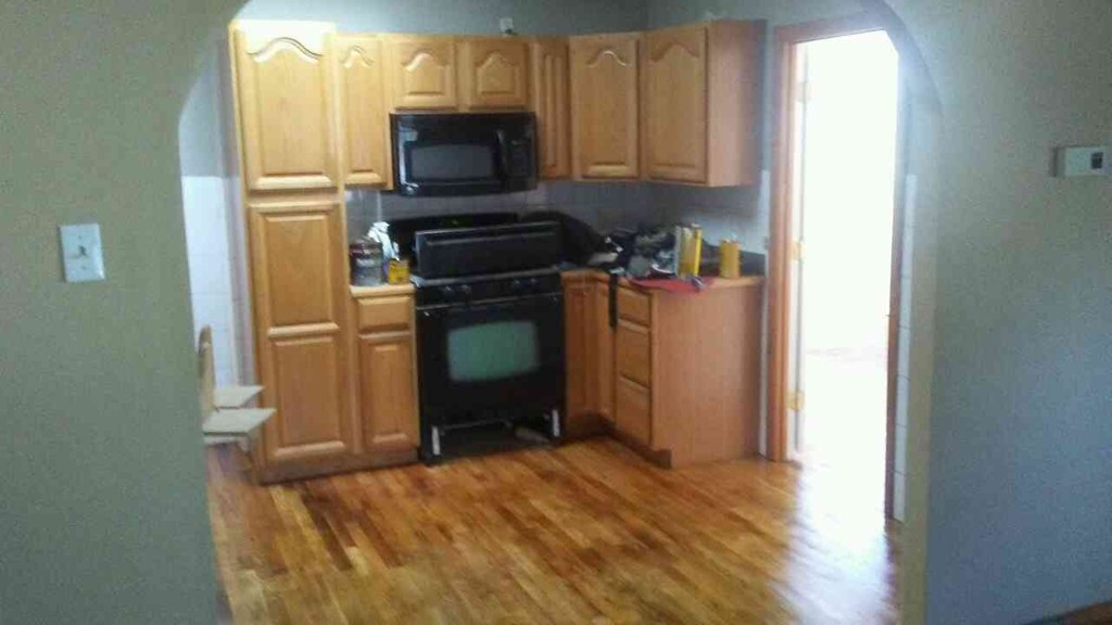 2 Pinckney Street Taunton, MA 02780 - Photo 2 of 5 a kitchen with a refrigerator and a stove