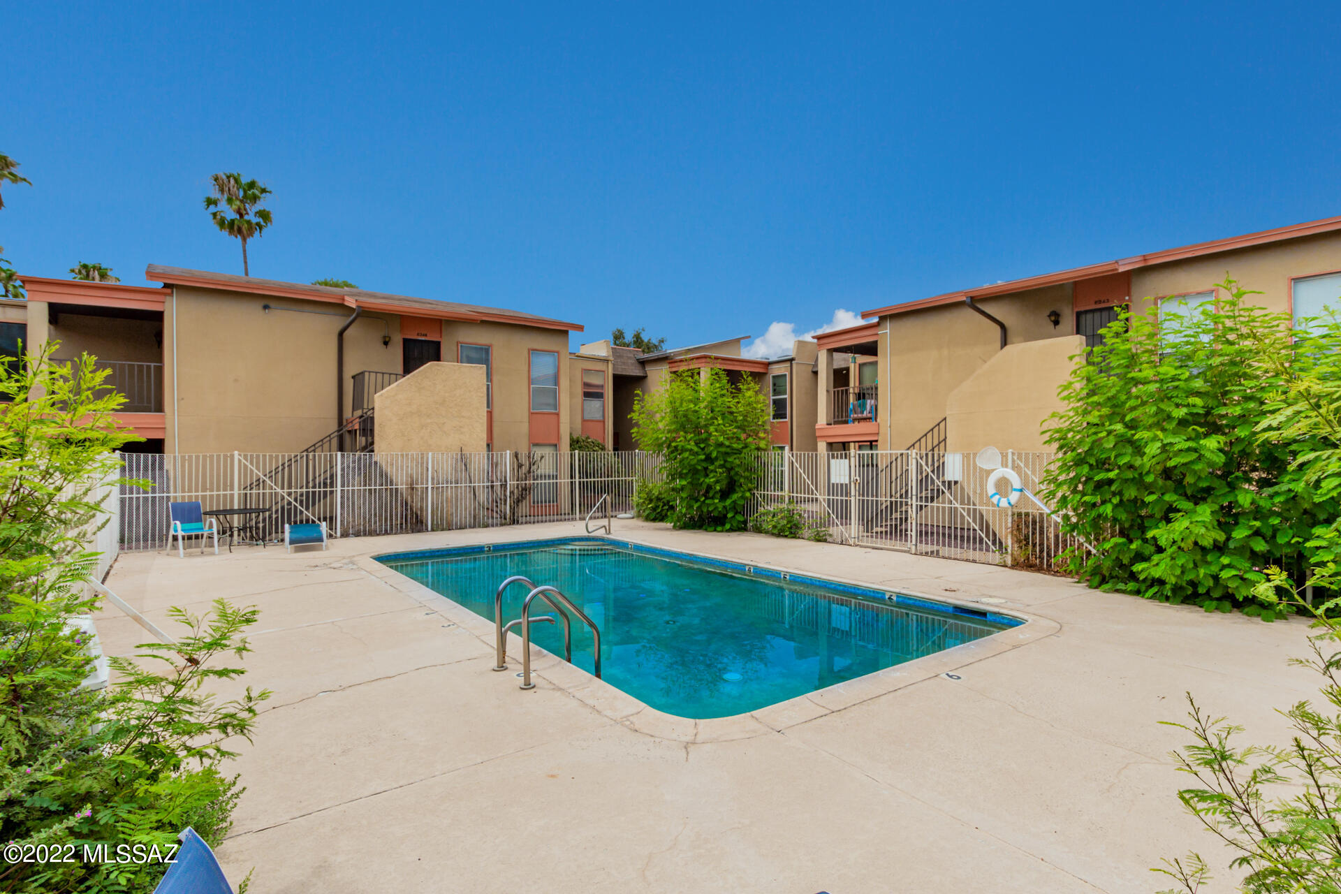 1620 North Wilmot Road, Unit D273 Tucson, AZ 85712 - Photo 12 of 15 a swimming pool with outdoor seating and yard