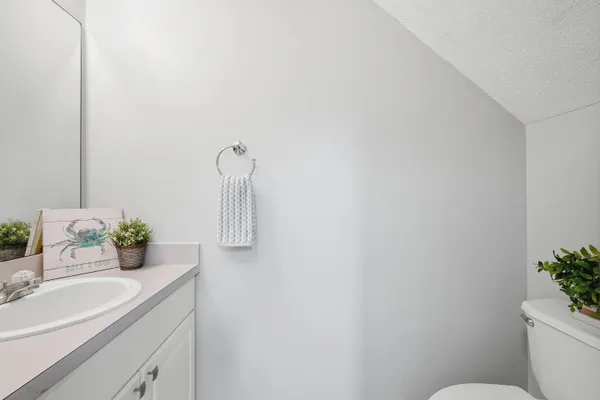 a bathroom with a sink toilet and mirror