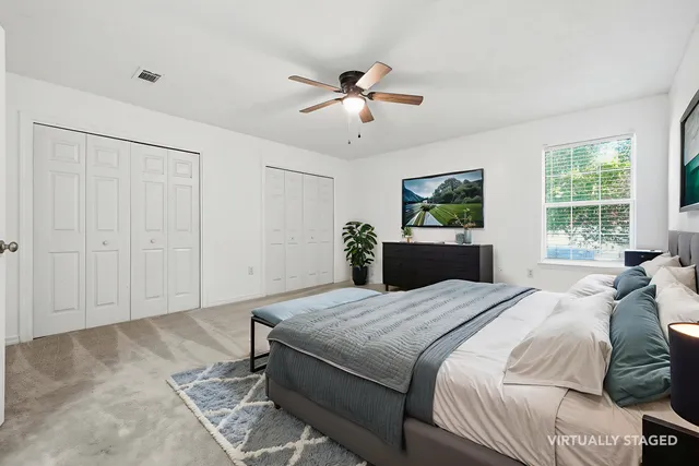 a bedroom with a large bed and a chandelier